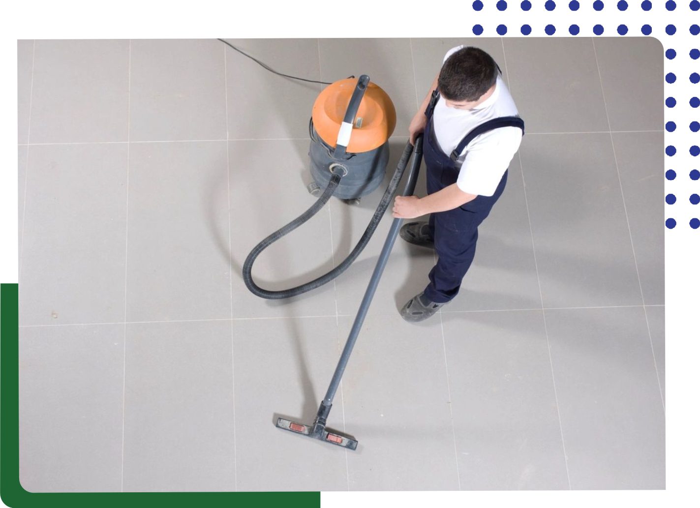 A man is vacuuming the floor with an orange vacuum.