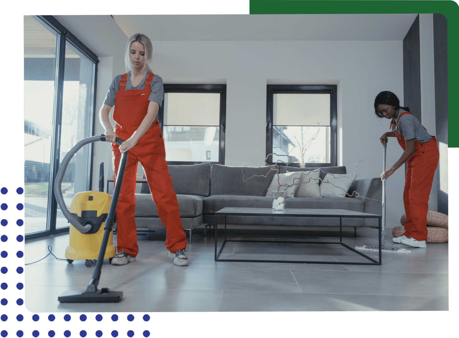 Two women in a living room with a vacuum.