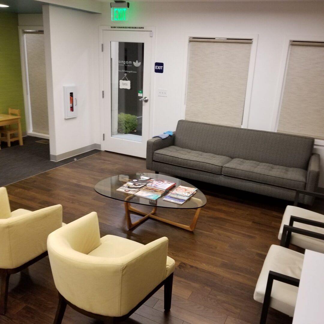 A living room with two chairs and a couch